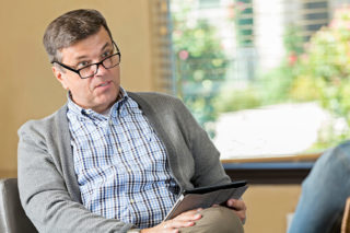 Mature adult male psychiatrist counseling a patient