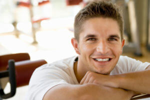 man smiling thinking about gender specific addiction treatment