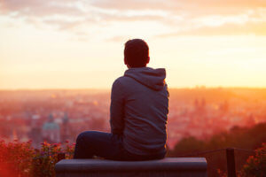 Young Man Looking Out Toward the City in Search of Heroin Detox