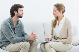 Man speaking with a female drug rehab counselor
