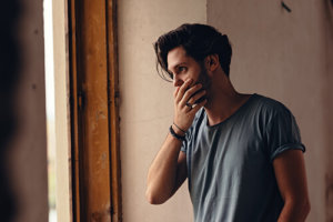 Stressed man experiencing the effects of alcoholism