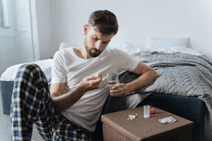 Man in His Bedroom Struggling with OxyContin Addiction