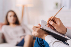 therapist taking notes during intensive outpatient IOP treatment program